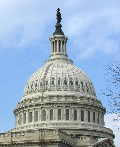 The cuppola of the U.S. Capitol Building against a blue sky